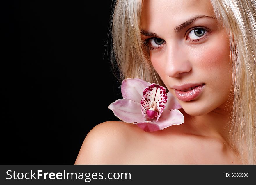 Face of beautiful young woman with delicate orchid. Face of beautiful young woman with delicate orchid