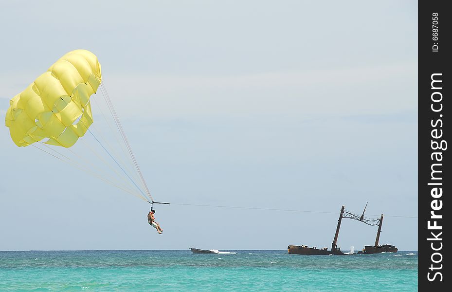 Boat driven parachute flight against blue sky