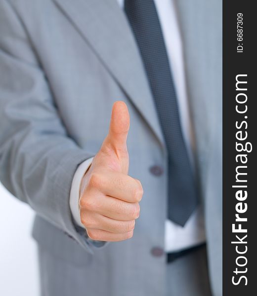 Portrait of handsome businessman showing thumb up hand sign