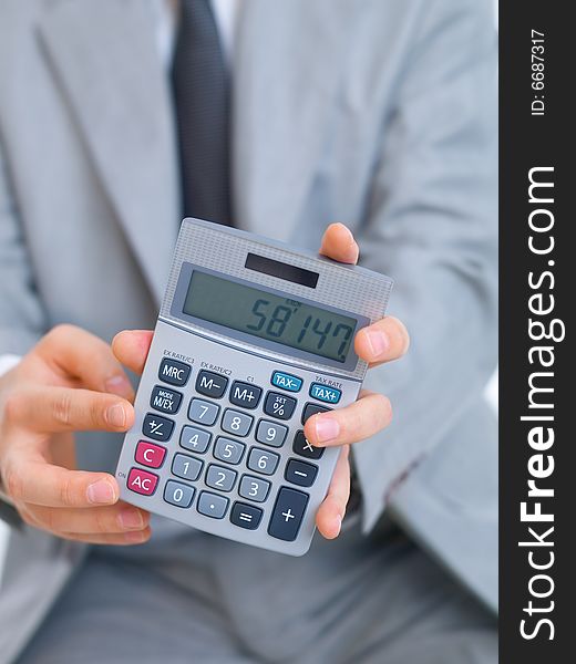 Close up of middle aged business man using calculator. Close up of middle aged business man using calculator