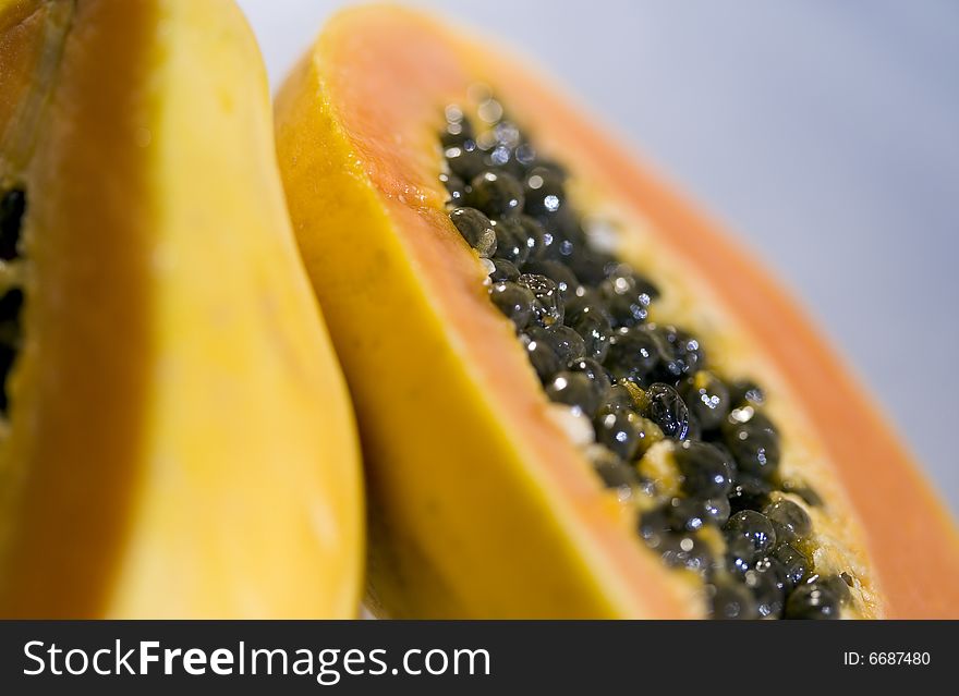 Delicious halved papaya fruit with focus on seeds. Delicious halved papaya fruit with focus on seeds