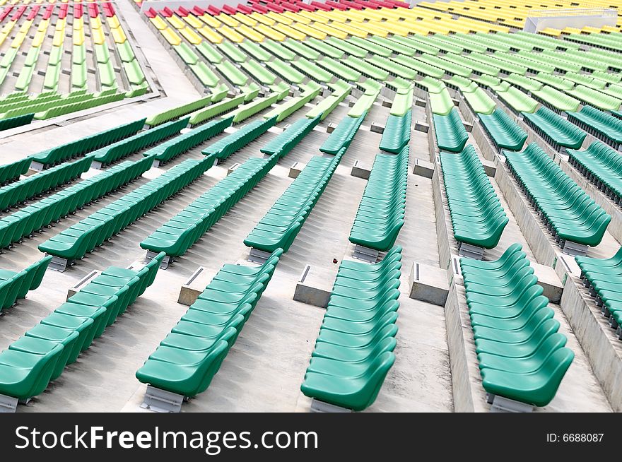 Coloured spectator chairs at the grand stand. Coloured spectator chairs at the grand stand