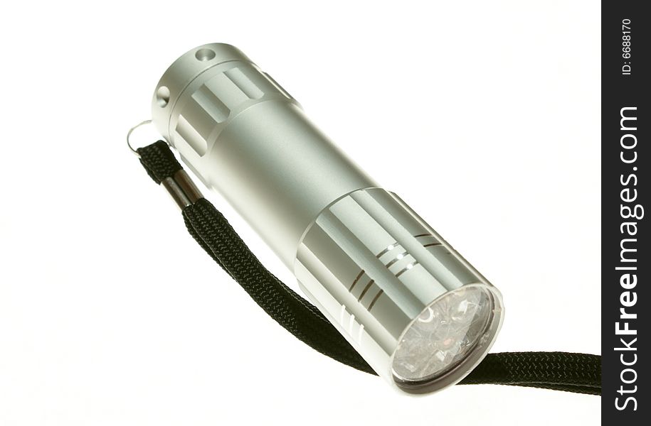 An electric flashlight on a white background. An electric flashlight on a white background
