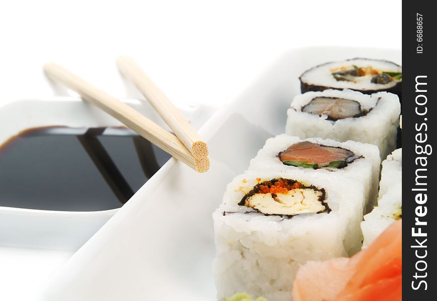 Sushi with chopsticks on white
