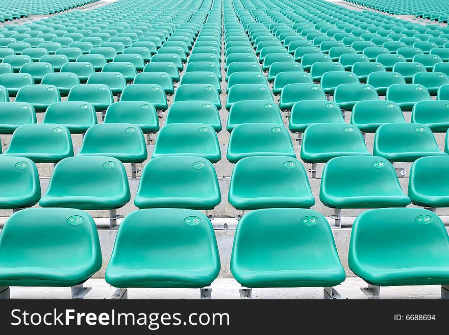 Coloured spectator chairs at the grand stand. Coloured spectator chairs at the grand stand