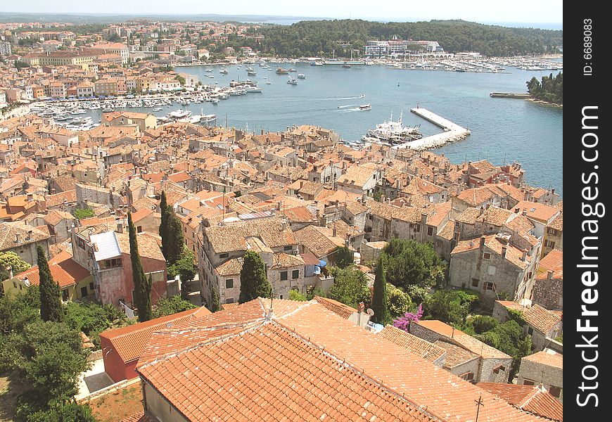 Croatia. Tile roofs of an old city and a convenient bay. Adriatic sea.