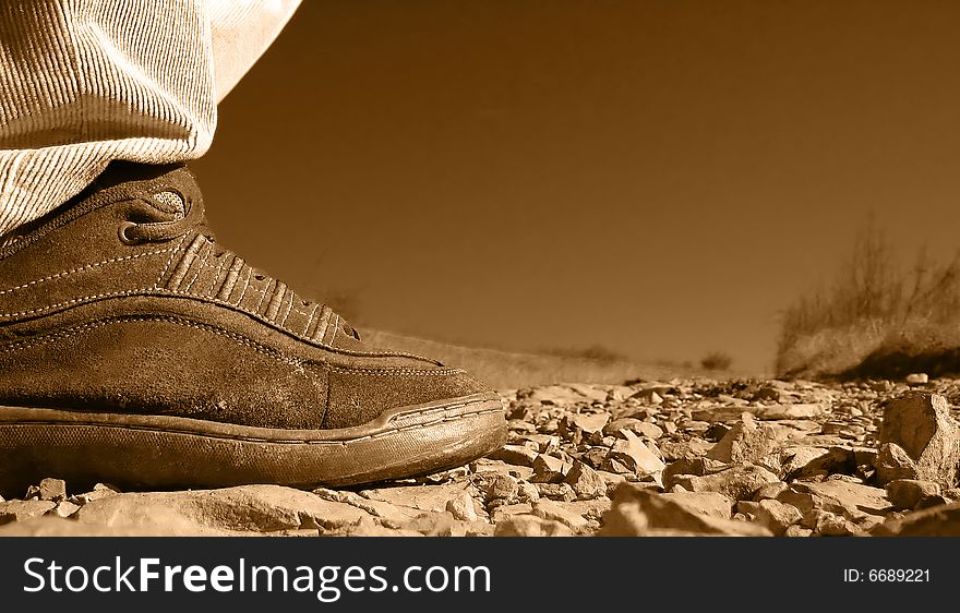 Close up of a man's shoe on a stone walk path. Close up of a man's shoe on a stone walk path