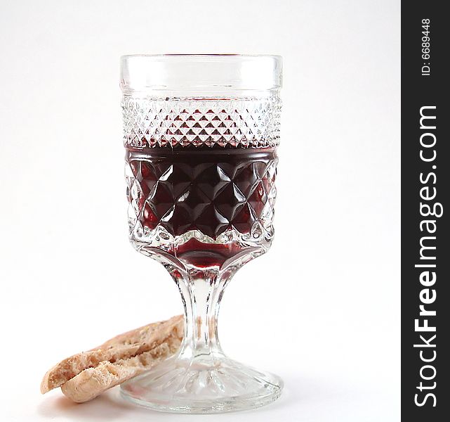 Glass of red wine with a piece of bread isolated on a white background. Glass of red wine with a piece of bread isolated on a white background