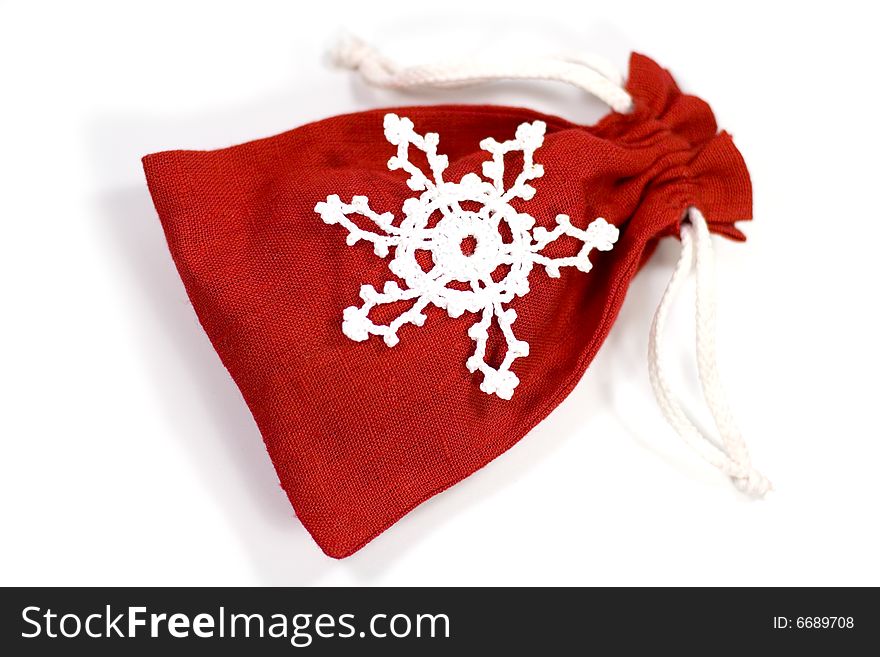 Red gift bag with decorative snowflake on white background