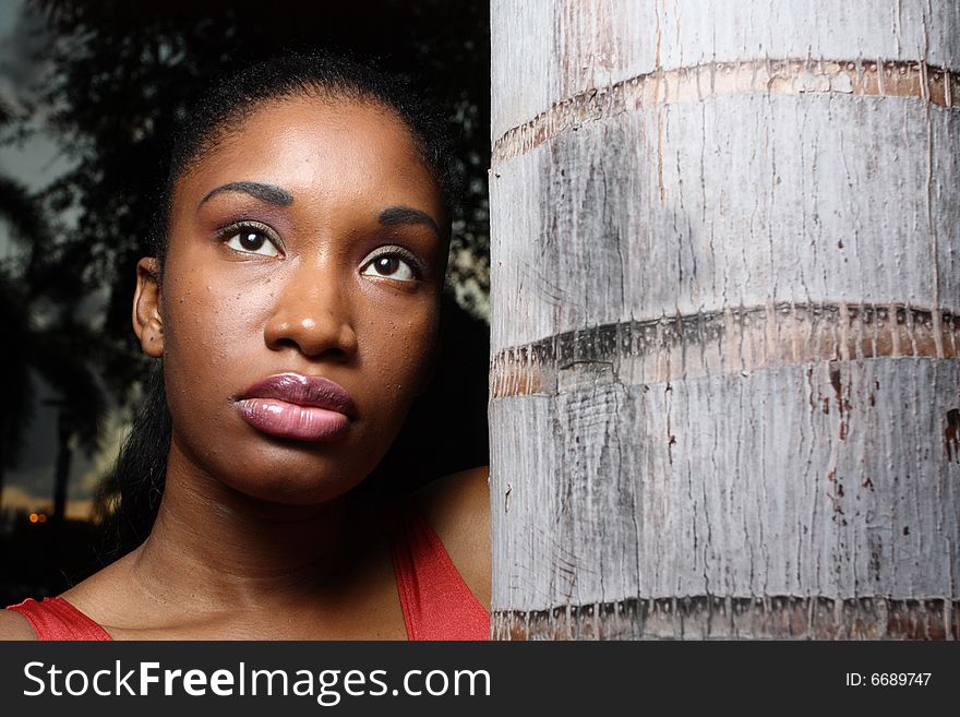 Female posing by a tree bark. Female posing by a tree bark