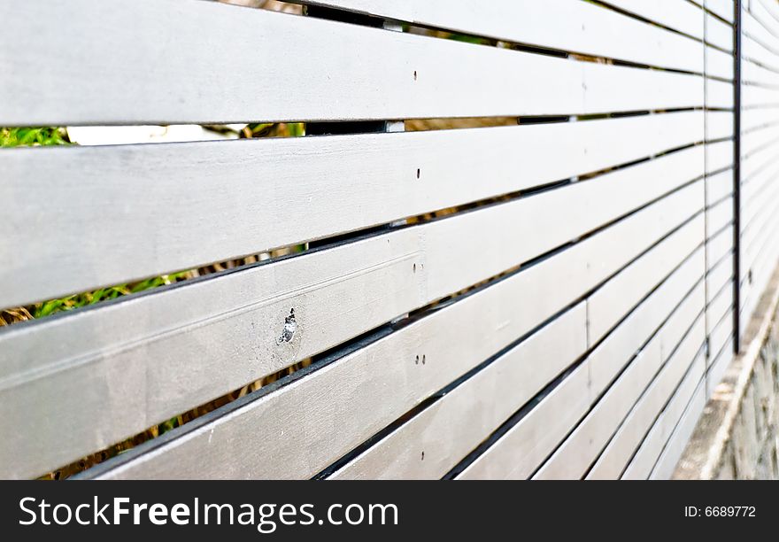 Some object behind the fence.Selective focus on the point of interest. Some object behind the fence.Selective focus on the point of interest