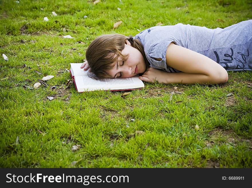 Young blonde taking a nap after reading. Young blonde taking a nap after reading