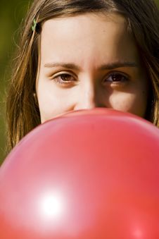 Young Woman Inflating Red Balloon Stock Image Young Woman Inflating Red Balloon Stock Image