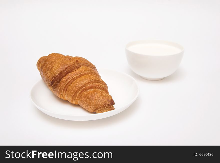 Croissant and milk isolated on white. Croissant and milk isolated on white