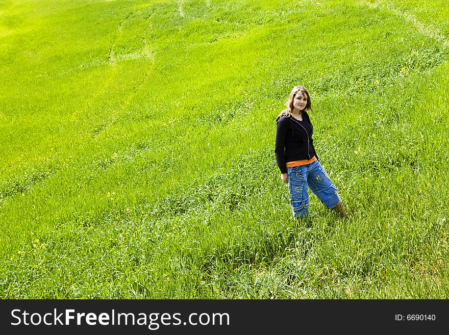 Young beautiful girl posing in meadow. Young beautiful girl posing in meadow.