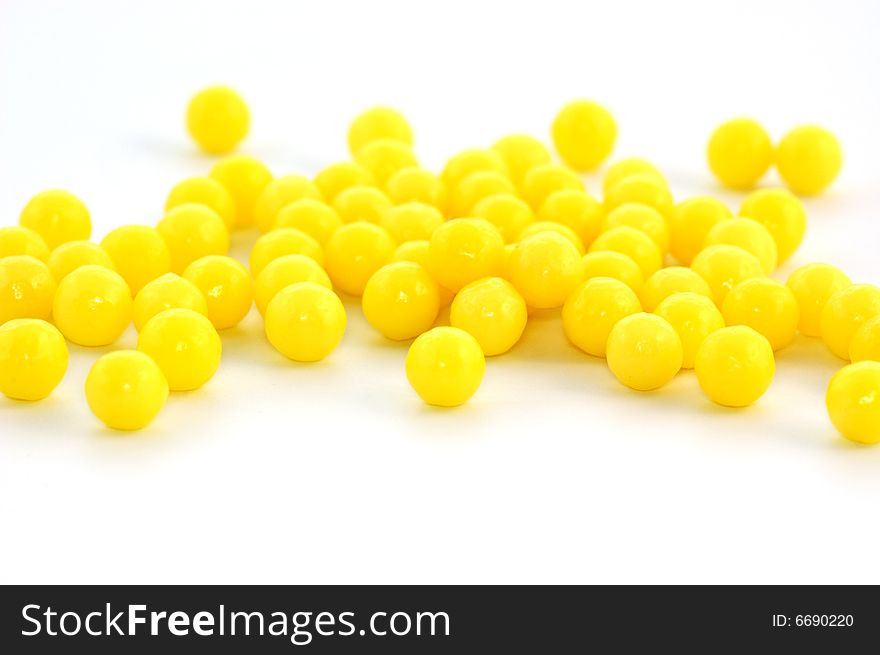 Many yellow pills on white