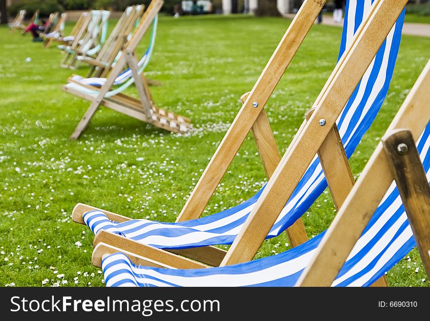 Empty deck chairs at St Jameï¿½s London Park. Focus on the third arm. Empty deck chairs at St Jameï¿½s London Park. Focus on the third arm.