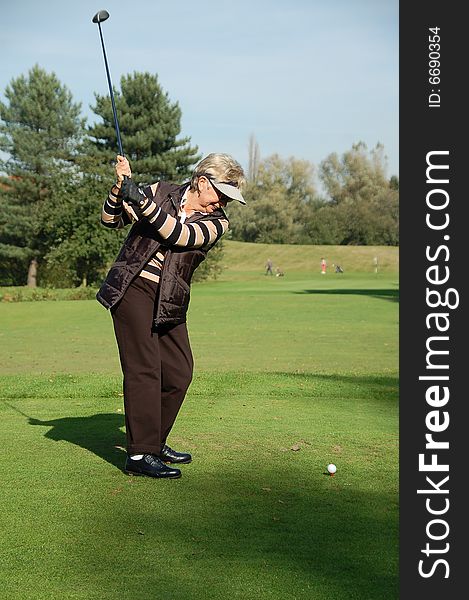 Female Golfer Teeing Off