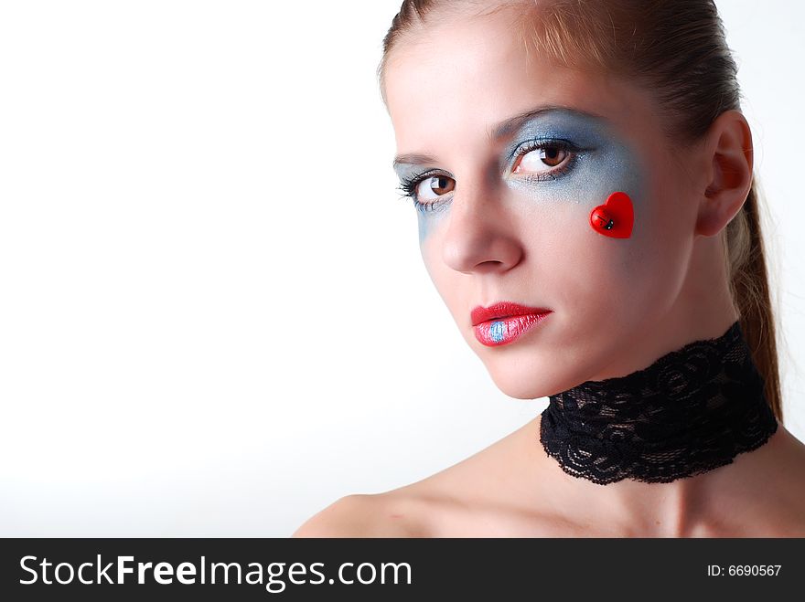 Portrait of a beautiful woman with blue eyeshadow and patch. Portrait of a beautiful woman with blue eyeshadow and patch