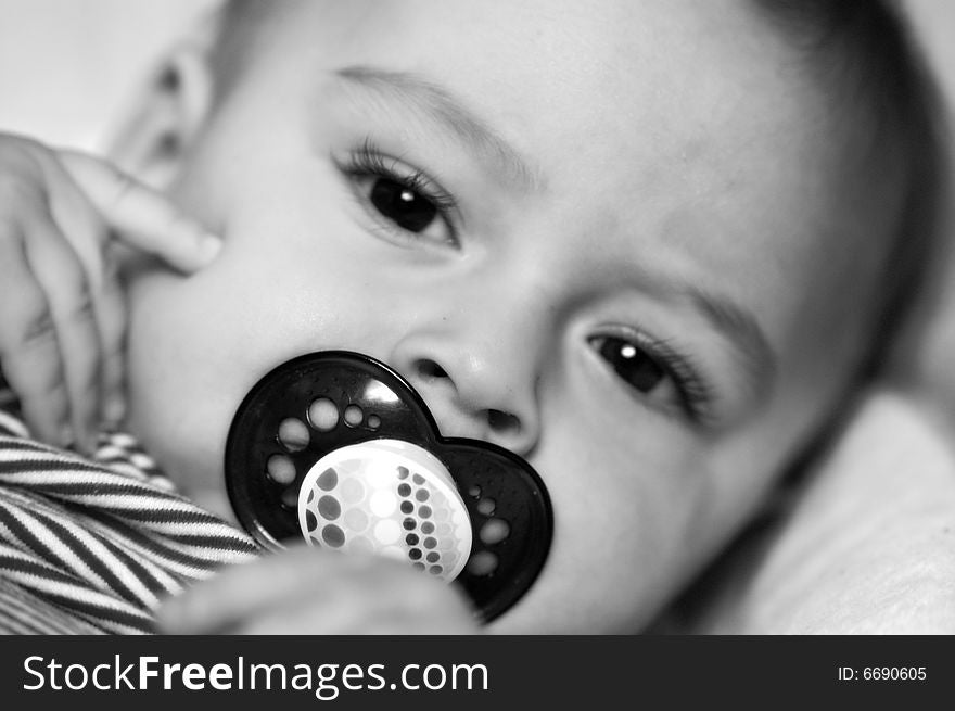 Beautiful baby sucking on his binky. Beautiful baby sucking on his binky