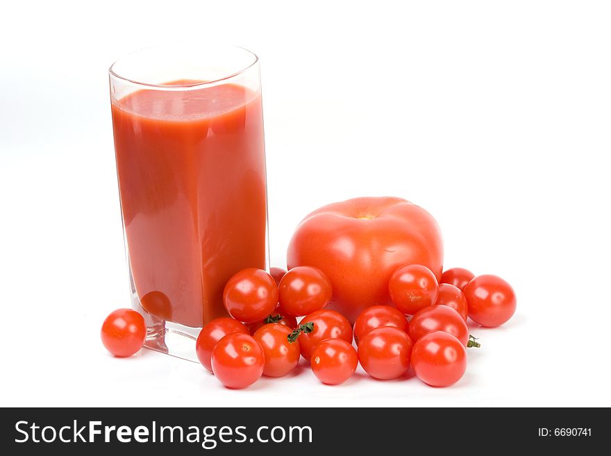 Tomatoes and juice on a white background