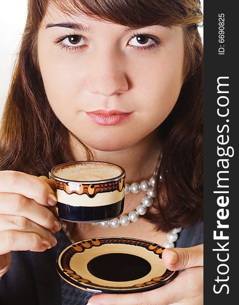 Young woman is holding a small coffee cup. Young woman is holding a small coffee cup