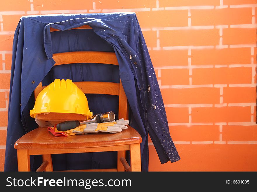 A chair is working clothes and tools. A chair is working clothes and tools