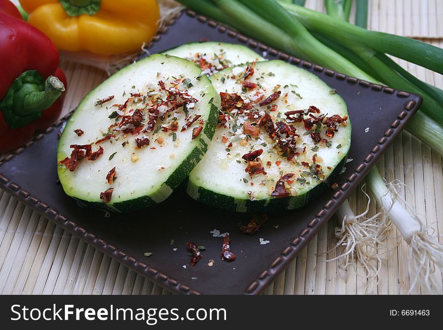 Some pieces of a fresh zucchini with some spices