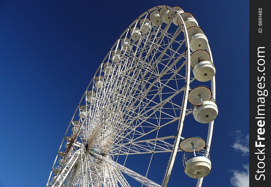Ferris Wheel in Paris, blue  sky behind