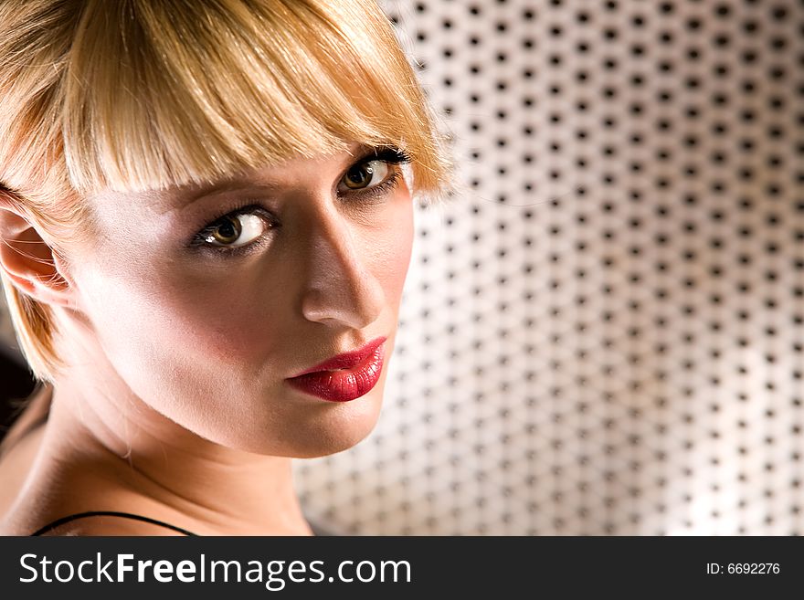 Portrait of a beautiful blond girl looking at you