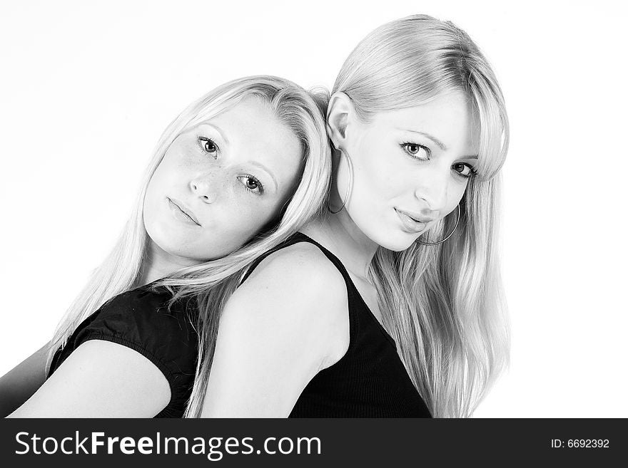 Studio portrait of two sisters looking sensual into the camera. Studio portrait of two sisters looking sensual into the camera