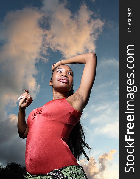 Young female with a beautiful blue sky in the background. Young female with a beautiful blue sky in the background.