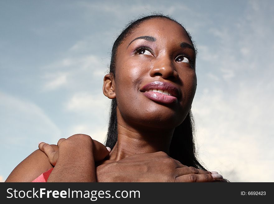 Young female with a beautiful blue sky in the background. Young female with a beautiful blue sky in the background.