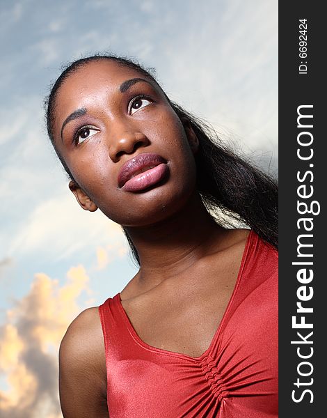 Young female with a beautiful blue sky in the background. Young female with a beautiful blue sky in the background.