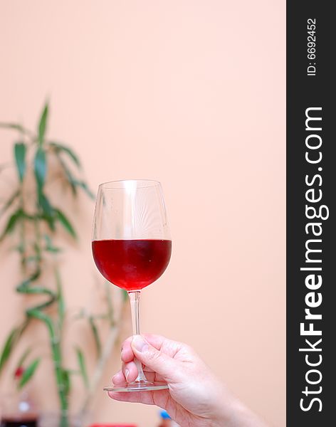 Picture of one hand holding a glass of wine. Picture of one hand holding a glass of wine