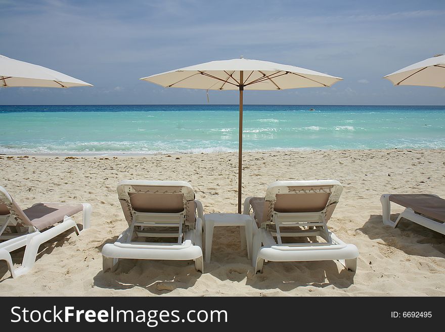 Beach scenic with lounge chairs and umbrella. Beach scenic with lounge chairs and umbrella