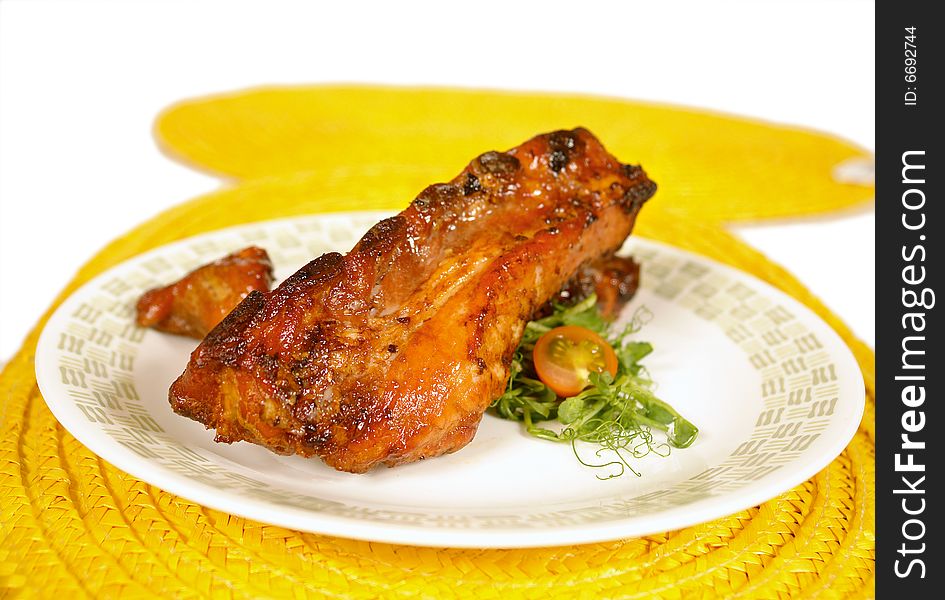 Honey glazed pork ribs served on salad