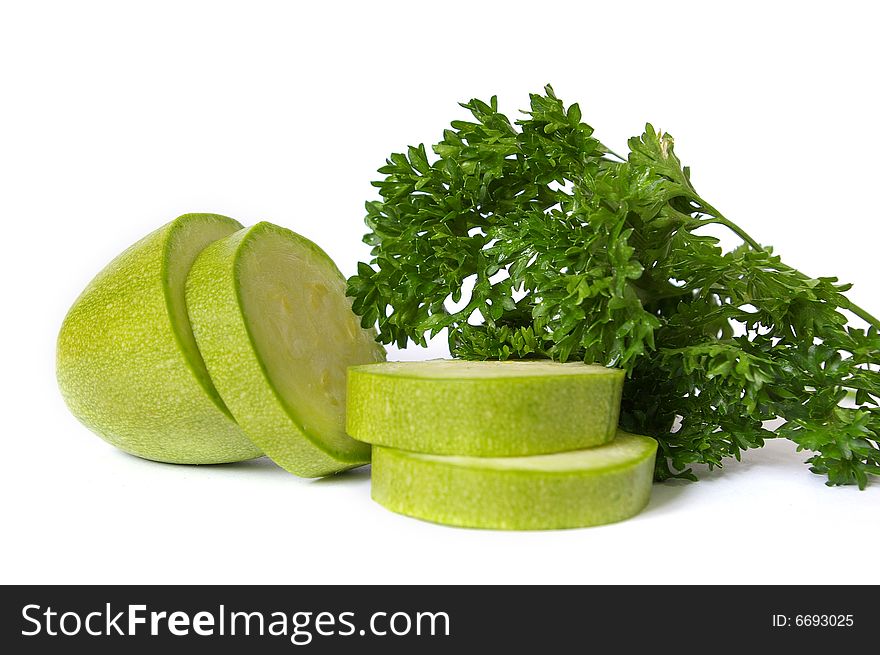 Raw cut zucchin and parsley isolated on white background