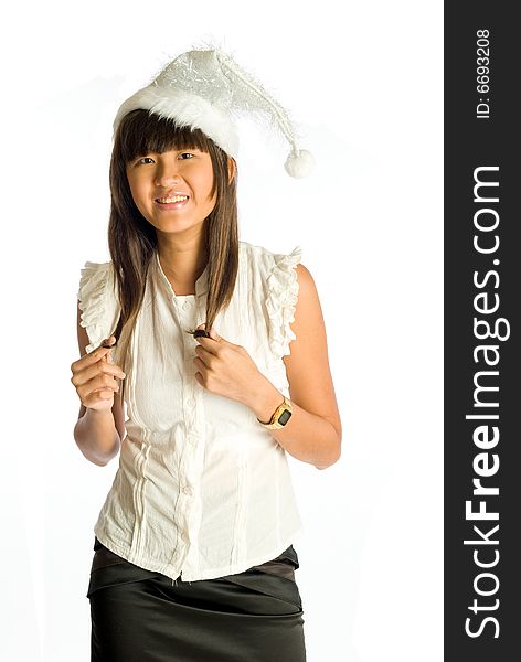 Lanky teenager long-haired Asian girl in silvery Santa Claus hat ready for a Christmas party. Lanky teenager long-haired Asian girl in silvery Santa Claus hat ready for a Christmas party.