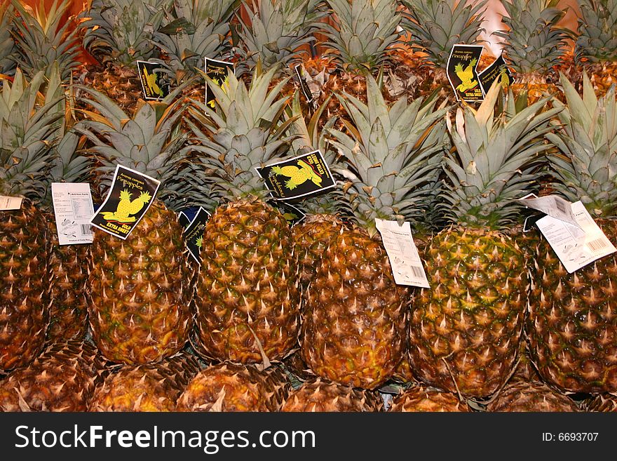 Alot of pineapples on stand in Market in Spain