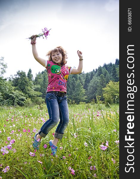A girl jumpping and holding A bouquet of flowers. A girl jumpping and holding A bouquet of flowers