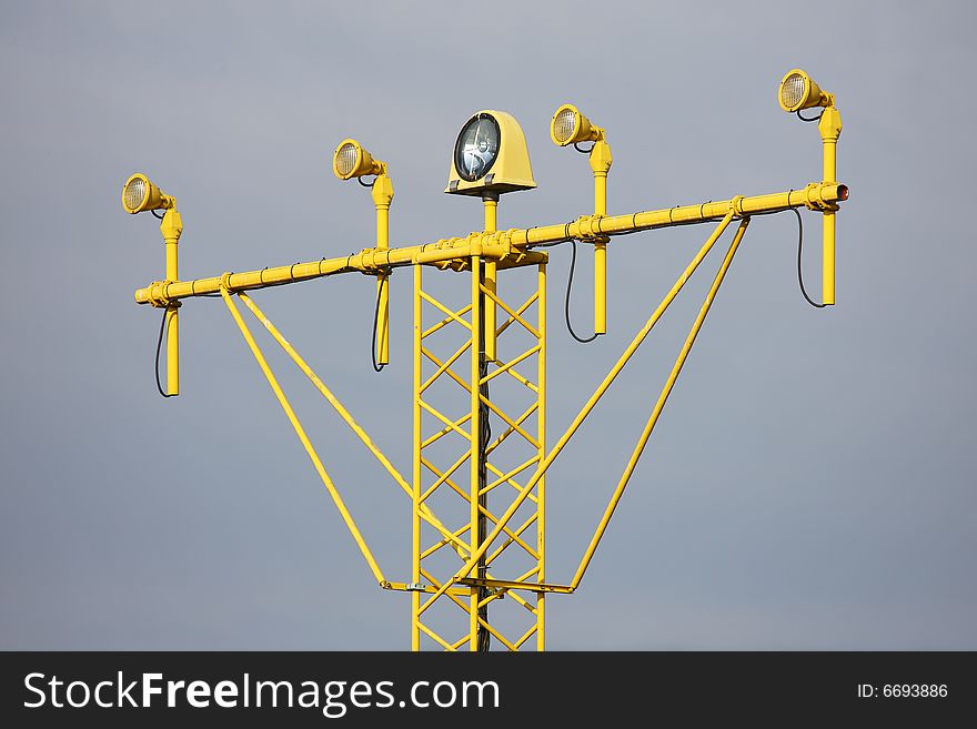 Yellow ILS runway lamp over cloudy sky. Yellow ILS runway lamp over cloudy sky