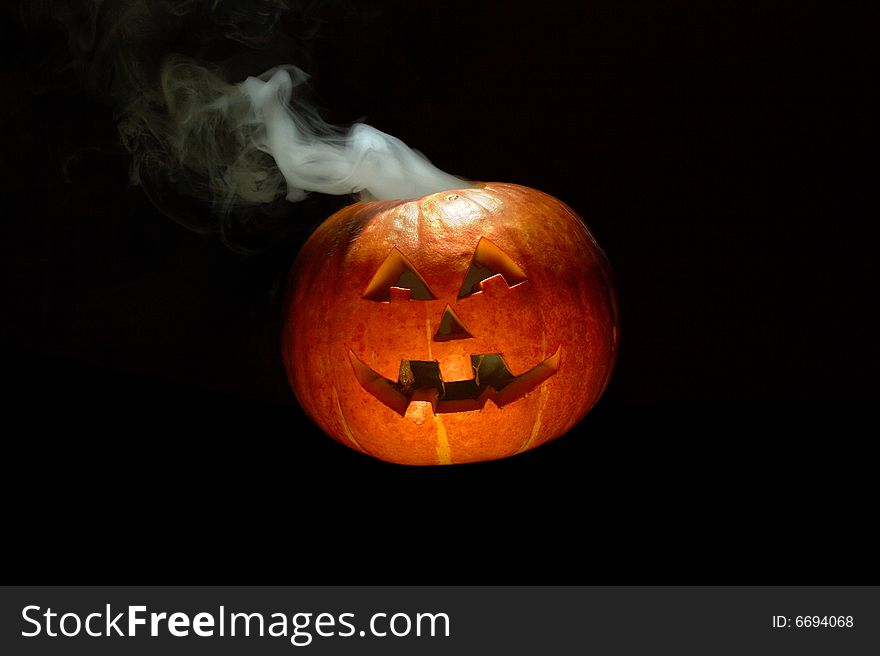 Halloween pumpkin with smoking crown of the head. Halloween pumpkin with smoking crown of the head