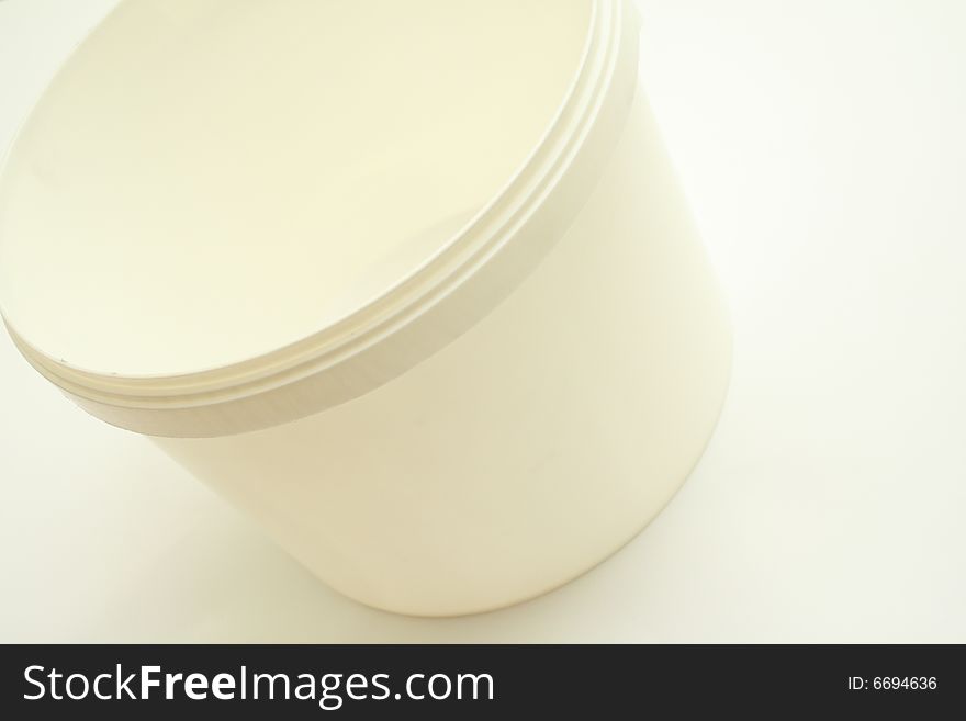 Against the backdrop is a white plastic bucket with a handle