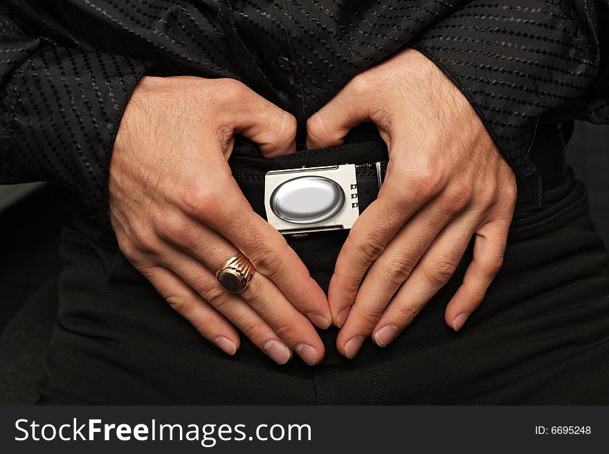 Male hands forming the heart shape over a belt-plate