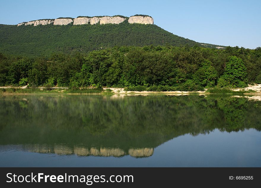 Beautiful lake with mountains reflected in water. Beautiful lake with mountains reflected in water