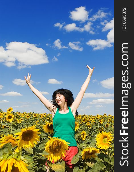 Fun woman in the field of sunflowers