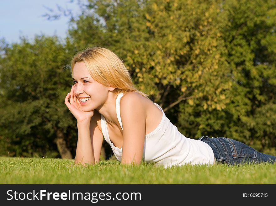 Sweet woman rest on the green summer grass