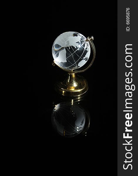 Little glassy globe with reverberation standing on dark background
