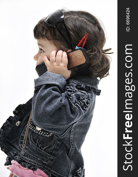 Portrait of little girl which speaks by phone. Portrait of little girl which speaks by phone